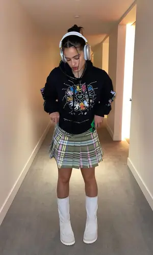 Rosalia’s Outfit in Claire Barrow Hoodie, Maison Margiela Boots & Apple (2022)