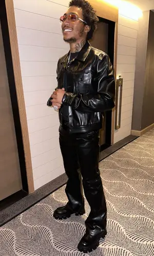 Lil Meech wearing Prada boots