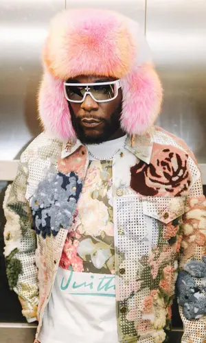 Burna Boy wearing Louis Vuitton jacket