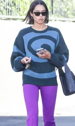 Laura Harrier wearing Chanel boots