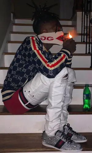 JayDaYoungan wearing Gucci sneakers