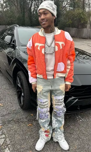 Lil Meech wearing Who Decides War jacket