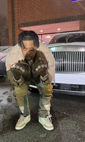 Finesse2tymes wearing Burberry jacket