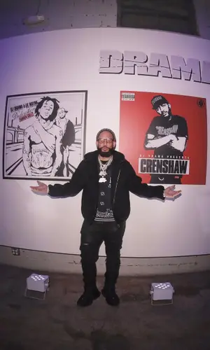 DJ Drama wearing Louis Vuitton jacket