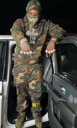 Finesse2tymes wearing Supreme hoody