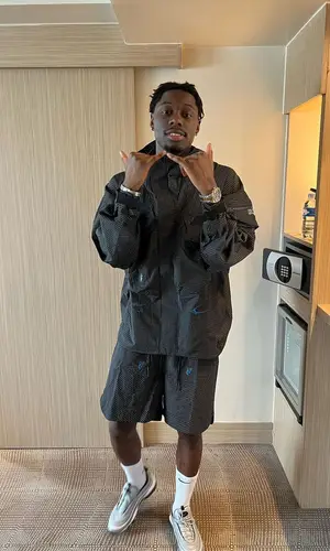 Tiakola wearing Nike shorts