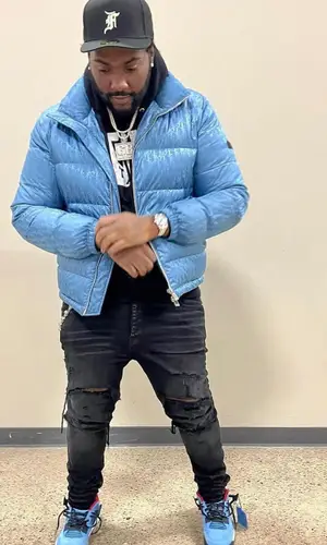 Peezy wearing Fear of God cap