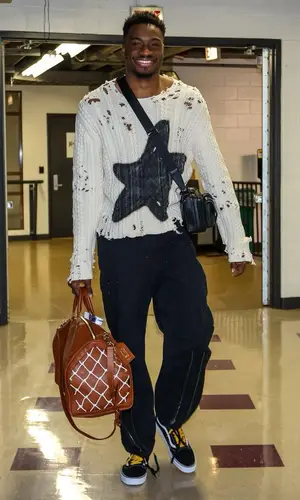 Thanasis Antetokounmpo’s Outfit in No Vacancy Inn Pants, Louis Vuitton Bag & NBA (2022)
