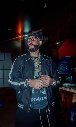 DJ Drama wearing Rhude jacket