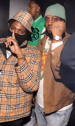 Peezy wearing Burberry shirt
