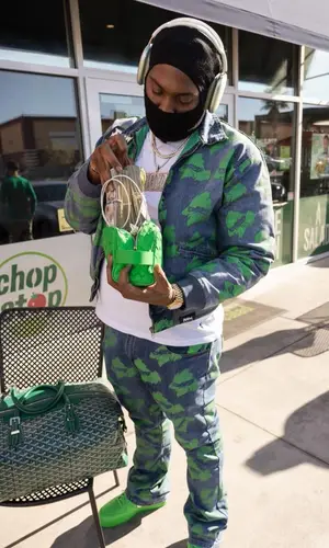 Peezy wearing Roadrunners World Global jacket
