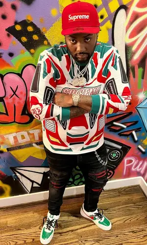 Peezy wearing Supreme cap