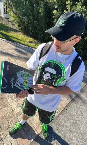 Feid’s Outfit in Bape T-Shirt, Cartier Eyewear & Razer (2023)