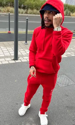 Green Montana wearing Adidas pants