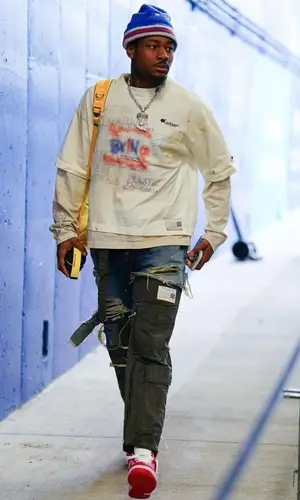 Stefon Diggs’ Outfit in Louis Vuitton Sneakers, Undercover Backpack & Acne Studios Hat (2023)