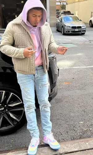 Myke Towers wearing ERL hoody