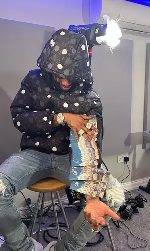 Russ Millions wearing Louis Vuitton belt