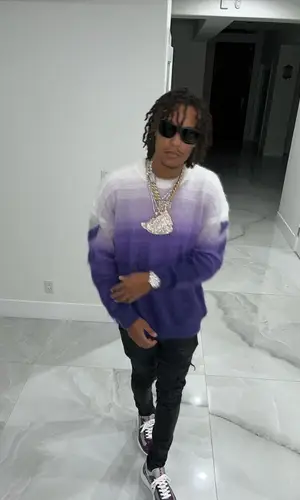 Skilla Baby’s Outfit in Off-White Sweater, Amiri Jeans & Prada Sneakers (2023)