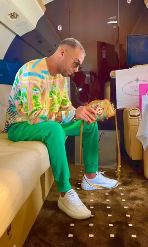 Naps wearing Versace sneakers