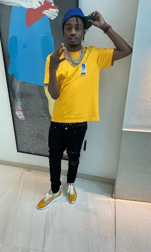 Lil Tjay wearing Rhude cap