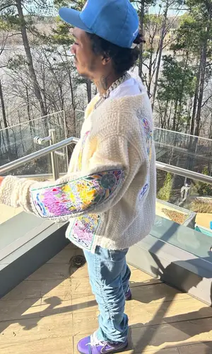 Lil Meech wearing Who Decides War jacket