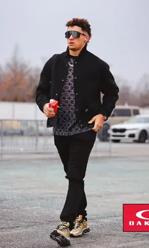 Patrick Mahomes II’s Outfit in Louis Vuitton Jacket, Amiri Jeans & Oakley Eyewear (2023)
