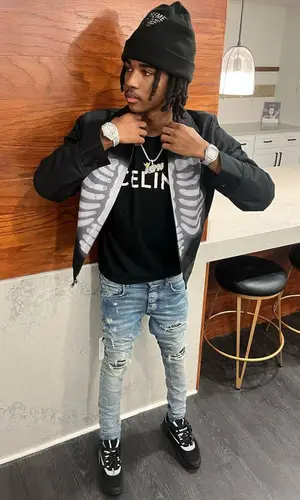 Lil Darius wearing Supreme hat