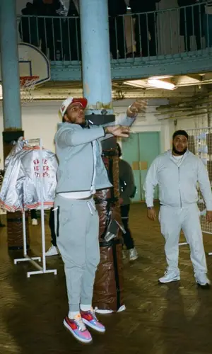 AJ Tracey’s Outfit in Nike Hoodie, Undefeated Sneakers & New Era Cap (2023)