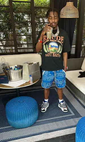 Lil Tjay wearing Heron Preston hat