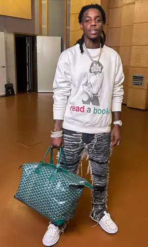 OMB Peezy wearing Denim Tears jacket