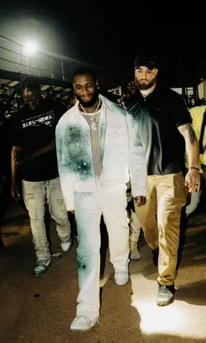 Burna Boy wearing Louis Vuitton jacket