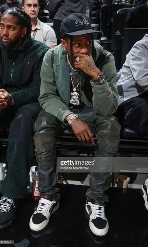 Travis Scott wearing Raf Simons sweater