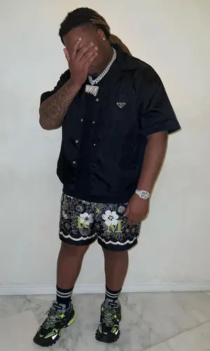 Tay Keith’s Outfit in Prada Shirt, Amiri Shorts & Balenciaga Sneakers (2023)