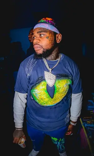Fat Boy wearing Playboi Artist t-shirt