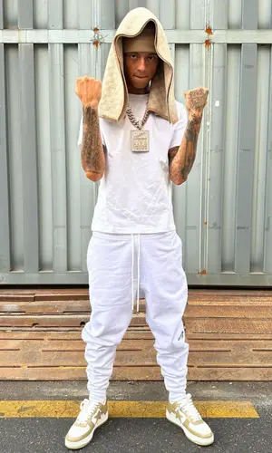 Central Cee wearing Louis Vuitton scarf