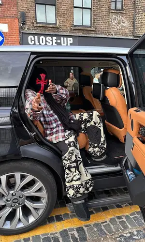 ASAP Nast’s Outfit in Balenciaga Shirt, Chrome Hearts Hat & Ugg Sandals (2023)