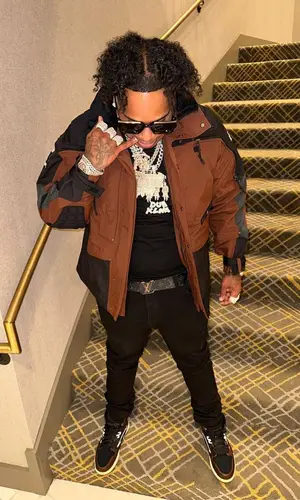 Finesse2tymes’ Outfit in Supreme Jacket, Louis Vuitton Belt & The North Face (2023)