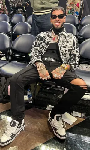 Anuel AA wearing Louis Vuitton jacket