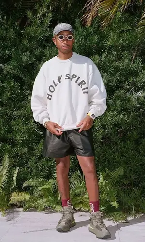 Pharrell Williams wearing Kanye West Merch sweatshirt