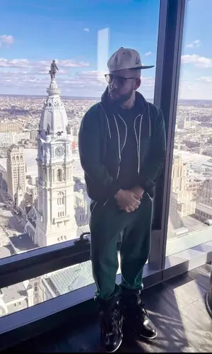 DJ Drama wearing Louis Vuitton jacket