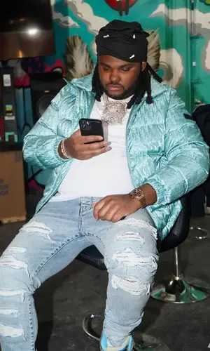 Tee Grizzley wearing Amiri jeans