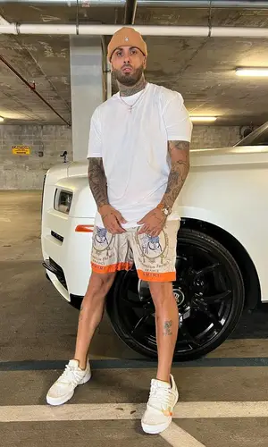Nicky Jam’s Outfit in Amiri Shorts, Off-White Sneakers & Obey Hat (2023)
