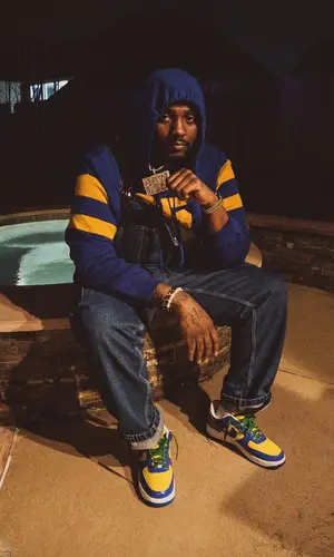 Peezy wearing Supreme pants