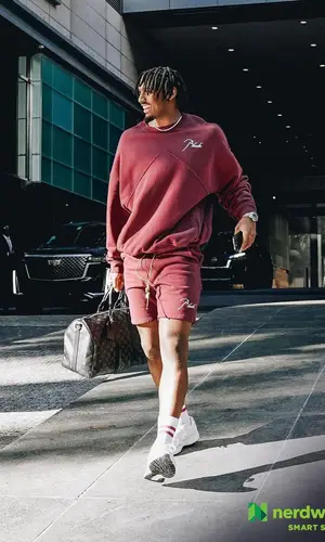 Tyrese Maxey wearing Rhude sweatshirt