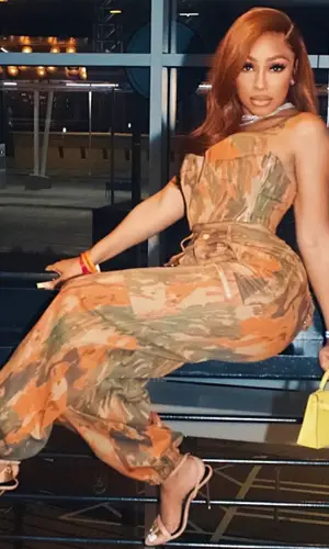 Yung Miami’s Outfit in Dion Lee Trousers, Hermes Bag & Tom Ford Sandals (2023)