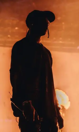 Travis Scott wearing Travis Scott Merch sweatshirt
