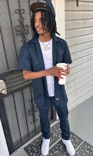 Lil Darius wearing New Era cap