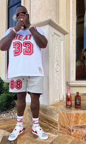 Rick Ross wearing Miami Heat shorts