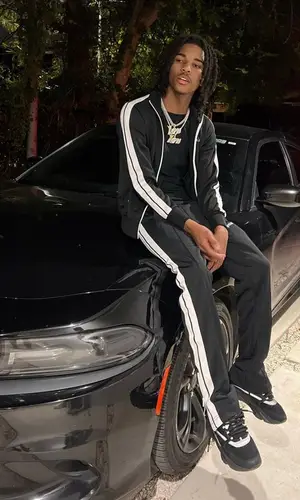Lil Darius wearing Palm Angels pants