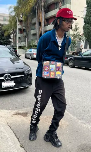 Onlybino wearing Supreme cap